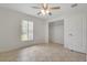 Neutral bedroom features a ceiling fan, a window view and closet with ample storage at 14091 Sw 32Nd Terrace Rd, Ocala, FL 34473