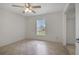 Neutral bedroom features a ceiling fan, a window view and an open closet with ample storage at 14091 Sw 32Nd Terrace Rd, Ocala, FL 34473