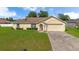 Charming single-story home with a well-maintained lawn and attached two-car garage at 14091 Sw 32Nd Terrace Rd, Ocala, FL 34473
