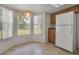 Bright breakfast nook with ample natural light, classic cabinets, and a white refrigerator at 14091 Sw 32Nd Terrace Rd, Ocala, FL 34473