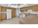 Functional kitchen featuring white appliances and ample wooden cabinet space at 14091 Sw 32Nd Terrace Rd, Ocala, FL 34473