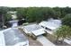 Aerial perspective of a lovely home with carport in a lively community, complete with a scenic pond and mature trees at 143 Piedmont Park Ave, Davenport, FL 33897