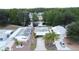 Overhead view of a charming home with a carport, located near a tranquil pond in a vibrant community at 143 Piedmont Park Ave, Davenport, FL 33897