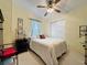 Bright bedroom features neutral carpet, soft yellow walls, a ceiling fan, and a closet for ample storage at 143 Piedmont Park Ave, Davenport, FL 33897