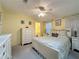 Comfortable bedroom featuring neutral decor, bright natural light, ceiling fan and an en-suite bathroom at 143 Piedmont Park Ave, Davenport, FL 33897