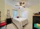 Comfortable bedroom with textured yellow walls, a ceiling fan, and a closet with white doors at 143 Piedmont Park Ave, Davenport, FL 33897