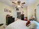Bedroom features carpet, a large bed, textured yellow walls, dark dressers, and two small pictures on the wall at 143 Piedmont Park Ave, Davenport, FL 33897