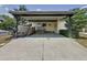 A covered carport provides parking and entry with a ramp to the front door of this charming home at 143 Piedmont Park Ave, Davenport, FL 33897