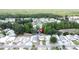 Idyllic aerial view of the community, featuring a scenic pond with a fountain and beautifully landscaped grounds at 143 Piedmont Park Ave, Davenport, FL 33897