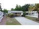 Charming home featuring a long driveway and covered parking at 143 Piedmont Park Ave, Davenport, FL 33897