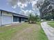 Charming home featuring a screened-in porch, mature palms, and an attached single-car garage at 143 Piedmont Park Ave, Davenport, FL 33897