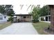 Charming single story home with well-maintained lawn and covered parking at 143 Piedmont Park Ave, Davenport, FL 33897