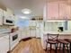 Traditional kitchen with white cabinetry, modern appliances, and breakfast bar at 143 Piedmont Park Ave, Davenport, FL 33897