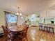Open layout with kitchen, dining area and wood laminate floors at 143 Piedmont Park Ave, Davenport, FL 33897