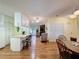 Open concept: kitchen, dining and living room with wood laminate flooring and ceiling fan at 143 Piedmont Park Ave, Davenport, FL 33897