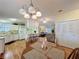 A view into an open concept kitchen, dining and living room with wood laminate flooring at 143 Piedmont Park Ave, Davenport, FL 33897