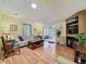 Comfortable living room featuring a fireplace, built-in shelving, and wood laminate flooring at 143 Piedmont Park Ave, Davenport, FL 33897