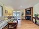 Inviting living room featuring a cozy fireplace, shelving, and access to an enclosed outdoor patio at 143 Piedmont Park Ave, Davenport, FL 33897