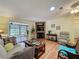 Spacious living room features a decorative fireplace, and large windows for lots of natural light at 143 Piedmont Park Ave, Davenport, FL 33897
