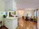 Open-concept living space featuring hardwood floors, decorative light fixture, and a view into the dining area at 143 Piedmont Park Ave, Davenport, FL 33897