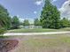 Scenic view of community pond with fountain and lush landscaping at 143 Piedmont Park Ave, Davenport, FL 33897