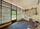 Enclosed sunroom features a ceiling fan, dark carpet, and a view to the backyard at 143 Piedmont Park Ave, Davenport, FL 33897
