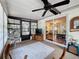 Sunroom with a ceiling fan, large windows, sliding glass doors, and a view to the backyard at 143 Piedmont Park Ave, Davenport, FL 33897