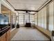 Bright sunroom with large windows, ceiling fan, sliding doors, and a view to the exterior at 143 Piedmont Park Ave, Davenport, FL 33897