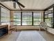 Relaxing sunroom with large windows, ceiling fan, and comfortable seating at 143 Piedmont Park Ave, Davenport, FL 33897