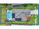 Property line outlining an aerial view showcasing a screened-in pool, lush landscaping, and a well-maintained roof at 1560 The Oaks Blvd, Kissimmee, FL 34746