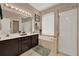 Bathroom with a double vanity, soaking tub, and a separate glass-enclosed shower at 1560 The Oaks Blvd, Kissimmee, FL 34746