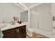 Clean bathroom with dark wood vanity, a single sink, and combined shower and tub at 1560 The Oaks Blvd, Kissimmee, FL 34746