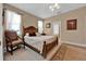 Comfortable bedroom with a wooden bed frame, plush bedding, and a bright window at 1560 The Oaks Blvd, Kissimmee, FL 34746