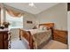 Bedroom with a wood frame bed, neutral decor, and a large window with valance at 1560 The Oaks Blvd, Kissimmee, FL 34746
