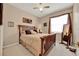 Tranquil bedroom with wood furnishings, a plush bed, and soft natural light at 1560 The Oaks Blvd, Kissimmee, FL 34746