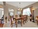 Formal dining room featuring a wood table, six chairs, and a decorative chandelier at 1560 The Oaks Blvd, Kissimmee, FL 34746