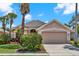 Charming single-story home boasting mature landscaping, two-car garage and neutral paint scheme at 1560 The Oaks Blvd, Kissimmee, FL 34746