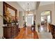 Bright foyer with wood floors, chandelier and elegant archways leading to dining and living areas at 1560 The Oaks Blvd, Kissimmee, FL 34746