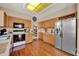 Spacious kitchen with wood floors, stainless steel refrigerator, and ample counter space at 1560 The Oaks Blvd, Kissimmee, FL 34746