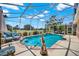 Sparkling screened-in pool area with comfortable seating, lush landscaping, and a serene water feature in the backyard at 1560 The Oaks Blvd, Kissimmee, FL 34746