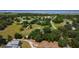 Expansive aerial view showcasing the property's large lot, mature trees, and proximity to a body of water at 1850 Orangewood Ave, St Cloud, FL 34772