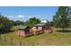 Aerial view of a uniquely designed home with a telescope dome and surrounding green space at 1850 Orangewood Ave, St Cloud, FL 34772