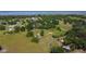 Expansive aerial view of the rural property with lush greenery and distant lake view at 1850 Orangewood Ave, St Cloud, FL 34772