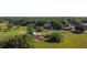 Aerial view showcases the property, featuring well-maintained grounds, various outbuildings, and a main house for versatile living at 1850 Orangewood Ave, St Cloud, FL 34772