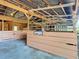 Barn interior features wooden stalls with metal bars, a concrete floor, and an open design for animal comfort and management at 1850 Orangewood Ave, St Cloud, FL 34772
