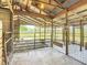 Barn's interior shows secure metal and wood enclosure with a chicken, providing a safe environment for animals on the property at 1850 Orangewood Ave, St Cloud, FL 34772