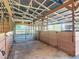 Barn interior offers sturdy wooden stalls with metal gating, ample natural light, and an open layout for animal wellbeing at 1850 Orangewood Ave, St Cloud, FL 34772