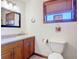 Well-lit bathroom with a vanity, toilet, and decorative accents for a warm, inviting feel at 1850 Orangewood Ave, St Cloud, FL 34772