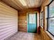 Cozy entryway with wood paneled walls, tile flooring, and a glass paneled door at 1850 Orangewood Ave, St Cloud, FL 34772