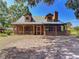 Beautiful log cabin with a metal roof and inviting screened-in porch, offering a serene retreat in a natural setting at 1850 Orangewood Ave, St Cloud, FL 34772